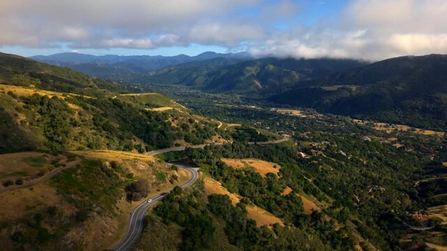 Panoramic summer mountain landscape view from the top with green valleys and cloudy sky in Carmel Valley, California