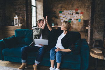 Tech entrepreneurs evaluate dashboard on laptop in sync—highlighting cloud metrics, UX interface,...