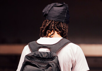 young man with a headscarf and backpack
