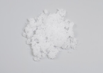 Magnesium nitrate powder on light grey background.