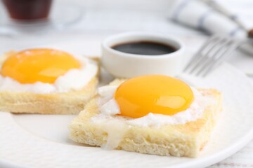 Tasty kaya toasts with half-boiled eggs served on table, closeup. Traditional asian breakfast