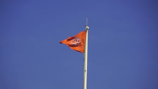 Saffron Flag Fluttering Gracefully in Clear Blue Sky Hindu Flag