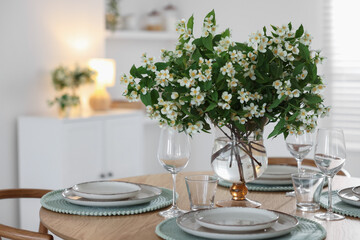 Bouquet of beautiful jasmine flowers on dining table indoors