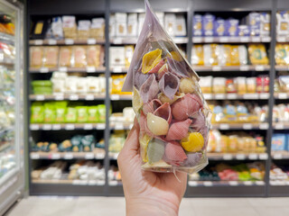 choosing spaghetti in a supermarket	
