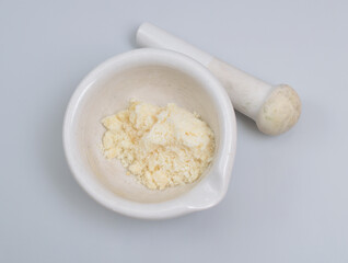 Sodium Oleate powder on light grey background.