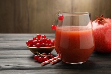 Superfood. Tasty smoothie in glass and ingredients on wooden table, closeup. Space for text
