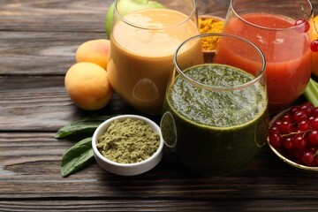 Superfood. Tasty smoothies in glasses and ingredients on wooden table, closeup