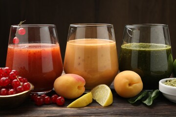 Superfood. Tasty smoothies in glasses and ingredients on wooden table, closeup