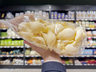 choosing spaghetti in a supermarket	
