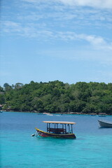 Tranquil Tropical Island Scene with Small Boat in Turquoise Water