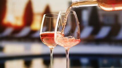 Orange or white rose wine bottle and glass against a sunset in a peaceful vineyard, pouring of ecological natural wine in hotel or sunset bar restaurant, cheers friends. - Powered by Adobe