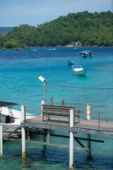Serene Tropical Pier with Boats and Turquoise Water