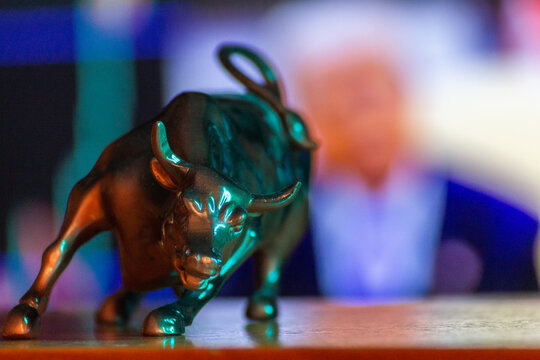 Market bull on the background of the stock chart .Stock market symbol bull on green background, sanctions, tariffs, market fluctuations Volatility US market