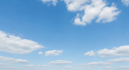 Bright blue sky with white fluffy clouds on a sunny day. Beautiful scenic background.