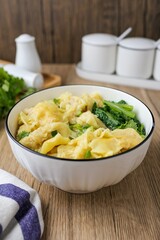 Wonton with bok choy Soup in a ceramic bowl	