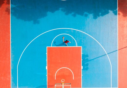 Aerial view of vibrant basketball court with player.