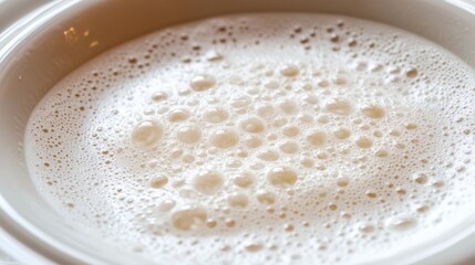 Creamy Foam with Bubbles in a White Bowl Close-Up View