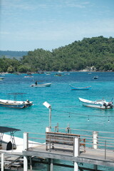 Tranquil Tropical Bay with Boats and Wooden Dock