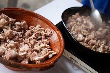 Pieces of cold cuts in a bowl and in a pan