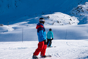People enjoy ski and snowboard for winter holiday in Alps area, Les Arcs 2000, Savoie, France,...