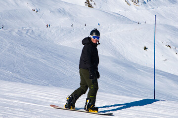 People enjoy ski and snowboard for winter holiday in Alps area, Les Arcs 2000, Savoie, France,...