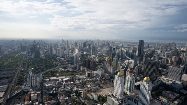 High angle view of Bangkok, the capital of Thailand. Skyscrapers on a cloudy day. Timelapse of Bangkok's skyline.