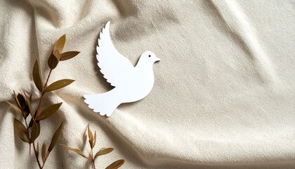 Dove paper cutout on linen background creating a serene atmosphere for peace and tranquility