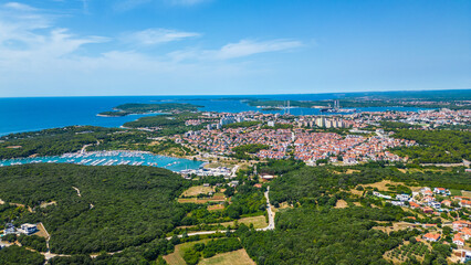 Fototapeta premium Aerial view of Pješčana Uvala near Pula, Croatia – beachside village, marina, turquoise sea and lush green coastline