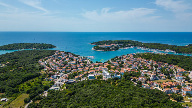 Aerial view of Pješčana Uvala near Pula, Croatia – beachside village, marina, turquoise sea and lush green coastline - Powered by Adobe
