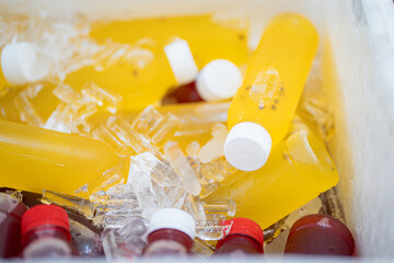 cold bottles of fresh fruit juice in bucket