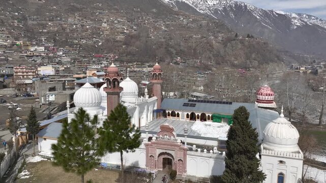 Aerial view of Chitral Central Mosque in Winter in Khyber-Pakhtunkhwa, Chitral, Pakistan. White Domes in sunny day