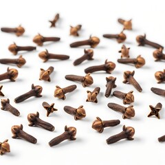 Scattered cloves, small spice pods, arranged on a white background.