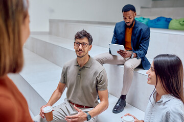 Business team engaging in discussion about a new project during an informal meeting in a modern...