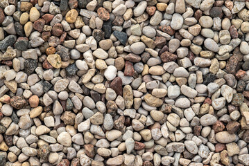 Seamless pattern of brown, grey, and white pebbles arranged in a natural, textured layout. Ideal for backgrounds, packaging, textile design, or spa and wellness-themed projects.

