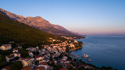Golden Hour Aerial View of Brela with Biokovo Mountain in the Background, Croatia