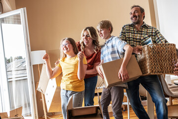 A family is moving into a new apartment, unpacking boxes together in the living room. They organize their belongings and start setting up their new home. 