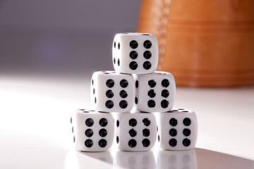 A random arrangement of dice and a puzzle cup, captured after the dice have been cast.