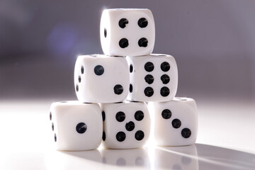 A random arrangement of dice and a puzzle cup, captured after the dice have been cast.