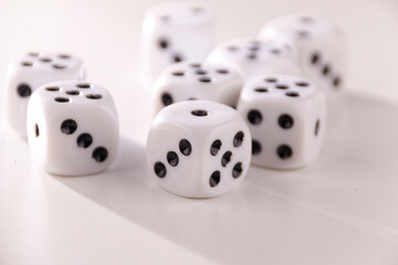 A random arrangement of dice and a puzzle cup, captured after the dice have been cast.