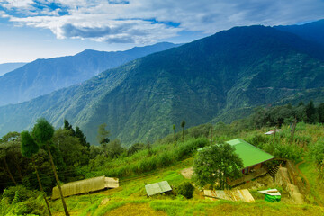 Okhrey village, Himalayan mountain range in the background . Okhrey is a remote village with breath...