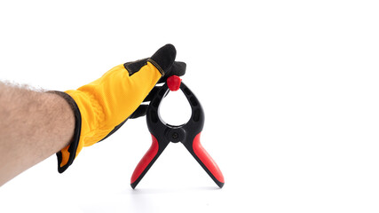 Hand holding a clamp tool for various tasks