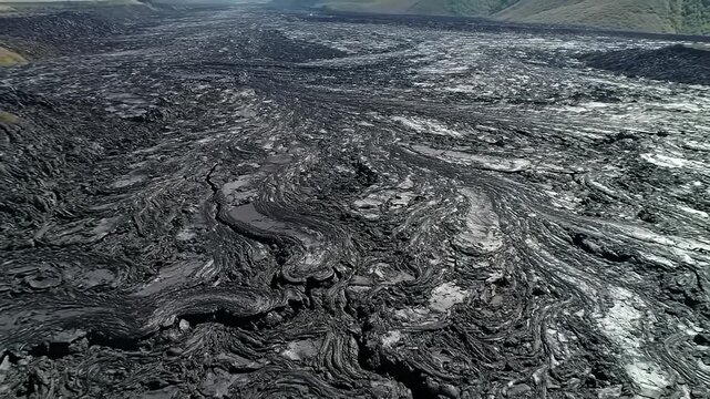 Aerial view of a textured, hardened lava field stretching to the horizon