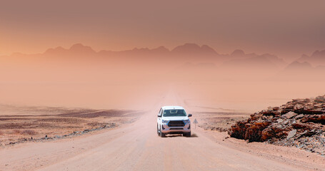 Suv vehicle rides through the sand dune Namib desert - Namibia © muratart