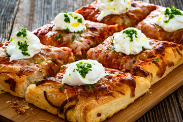 Pizza al metro margherita with burrata cheese on wooden table