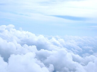 View from above the clouds showing a dreamy sky with soft, white cloud formations. Perfect for...
