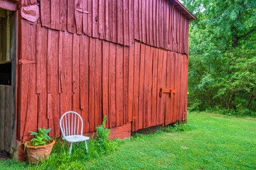 County Setting in rural Tennessee of a barn and a white chair.