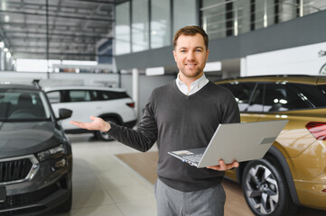 Portrait of Modern car seller standing in car salon with copy space