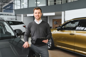 car dealer principal standing in showroom