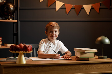 Child Doing Homework with Books and Globe – Back to School Theme