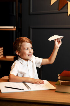 Child Doing Homework with Books and Globe &ndash; Back to School Theme